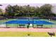 Well maintained blue and green tennis court is surrounded by dark fencing in this outdoor recreation area at 4916 Gathering Pl, Suwanee, GA 30024