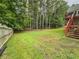 Expansive backyard, partially fenced, leading to a staircase to the rear deck of the home at 111 Bexley Ln, Douglasville, GA 30134