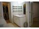 Bathroom with a single sink vanity, shelves and a walk-in closet for storage at 111 Bexley Ln, Douglasville, GA 30134