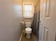 Bright bathroom featuring a standard white toilet and window with blinds at 111 Bexley Ln, Douglasville, GA 30134