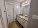 Well-lit bathroom with gray walls and vanity with storage space and a large mirror at 111 Bexley Ln, Douglasville, GA 30134