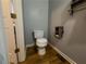 Small bathroom featuring a toilet with wood floors, providing a functional and cozy space at 111 Bexley Ln, Douglasville, GA 30134