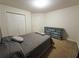 Bedroom with bed, dresser, and closet; features neutral paint and carpeting at 111 Bexley Ln, Douglasville, GA 30134