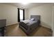 Bedroom with a neutral color scheme and queen bed next to large window at 111 Bexley Ln, Douglasville, GA 30134