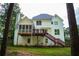 Rear view showcasing the deck and sunroom of this charming home, perfect for relaxation and enjoyment at 111 Bexley Ln, Douglasville, GA 30134