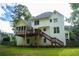 Rear exterior view features a spacious deck and sunroom, perfect for outdoor living and entertaining at 111 Bexley Ln, Douglasville, GA 30134