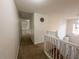 Bright hallway features neutral tones and stairs with white wood banister at 111 Bexley Ln, Douglasville, GA 30134
