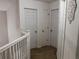 Upstairs hallway featuring three white panel doors and neutral carpeting at 111 Bexley Ln, Douglasville, GA 30134