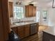 Well-lit kitchen with ample cabinetry, stainless steel appliances, and natural light creates an inviting cooking space at 111 Bexley Ln, Douglasville, GA 30134