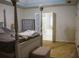 Spacious main bedroom features a four-poster bed, dresser, and ensuite bathroom at 111 Bexley Ln, Douglasville, GA 30134