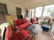 Relaxing screened porch with comfortable red furniture and a view of the backyard at 111 Bexley Ln, Douglasville, GA 30134