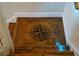 Stair landing with compass artwork, adding a unique decorative touch to the home's design at 111 Bexley Ln, Douglasville, GA 30134