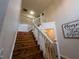 Staircase with natural wood steps and white railings, offering an inviting transition between floors at 111 Bexley Ln, Douglasville, GA 30134