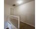 Upstairs hallway featuring a white railing and neutral carpet, providing a functional transition area at 111 Bexley Ln, Douglasville, GA 30134