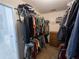 Walk-in closet with ample hanging space, shelving, and a glimpse into a bathroom at 111 Bexley Ln, Douglasville, GA 30134