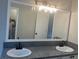 Bathroom with double sinks, granite countertops, large mirror and modern lighting at 7593 Watson Bay Ct, Stone Mountain, GA 30087