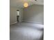 A carpeted bedroom featuring a vaulted ceiling, a modern light fixture, and an ensuite bathroom at 7593 Watson Bay Ct, Stone Mountain, GA 30087