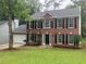 Traditional brick home featuring a well-manicured lawn and a two-car garage at 7593 Watson Bay Ct, Stone Mountain, GA 30087