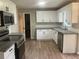 Modern kitchen with white cabinets, stainless steel appliances, and granite countertops at 7593 Watson Bay Ct, Stone Mountain, GA 30087