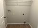 Simple laundry room with new flooring, hook ups, and storage shelf at 7593 Watson Bay Ct, Stone Mountain, GA 30087