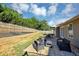 Spacious backyard featuring a patio area with outdoor seating and a well-maintained lawn at 109 Rockefeller Ln, Dallas, GA 30157