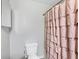 Clean bathroom featuring a toilet and ruffled shower curtain at 109 Rockefeller Ln, Dallas, GA 30157