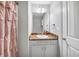 Well-lit bathroom featuring a vanity with a decorative framed mirror at 109 Rockefeller Ln, Dallas, GA 30157
