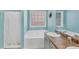Well-lit bathroom with a bathtub and vanity area at 109 Rockefeller Ln, Dallas, GA 30157