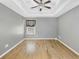 Spacious bedroom featuring hardwood floors and a tray ceiling with ceiling fan at 109 Rockefeller Ln, Dallas, GA 30157