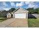 The home's exterior features a two-car garage, neutral siding, stone accents, and well-kept landscaping at 109 Rockefeller Ln, Dallas, GA 30157