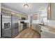 Modern kitchen features stainless steel appliances, granite countertops and tile backsplash at 109 Rockefeller Ln, Dallas, GA 30157