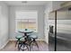 Cozy kitchen nook with a small table and chairs near a window, stainless refrigerator at 109 Rockefeller Ln, Dallas, GA 30157
