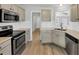 Charming kitchen boasts stainless steel appliances, sleek countertops, and ample cabinet space at 109 Rockefeller Ln, Dallas, GA 30157