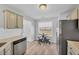Cozy eat-in kitchen featuring laminate flooring, bright light, modern appliances, and white subway tile backsplash at 109 Rockefeller Ln, Dallas, GA 30157