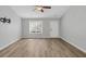 Bright and airy living room featuring neutral walls, laminate flooring, and a window with blinds at 109 Rockefeller Ln, Dallas, GA 30157