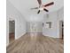 Open-concept living area featuring laminate flooring, neutral paint, and views into other rooms at 109 Rockefeller Ln, Dallas, GA 30157