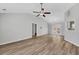 Bright open-concept space featuring laminate flooring, neutral paint, and modern ceiling fan and lighting at 109 Rockefeller Ln, Dallas, GA 30157