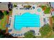 A pristine community pool surrounded by lounge chairs, umbrellas, and manicured landscaping in a neighborhood at 4495 Hedgewood Dr, Cumming, GA 30041