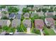 Aerial view of a two-story home with a well-manicured lawn and a paved driveway in a quiet neighborhood at 4495 Hedgewood Dr, Cumming, GA 30041