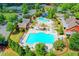 A vibrant community pool with slides, lounge chairs, umbrellas, and recreational areas surrounded by landscaping at 4495 Hedgewood Dr, Cumming, GA 30041