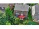 Aerial shot showcases the home's backyard deck and lawn area, enclosed by mature trees for privacy at 4495 Hedgewood Dr, Cumming, GA 30041