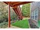 Backyard view showing a small grass area, and wooden stairs leading to the upper deck at 4495 Hedgewood Dr, Cumming, GA 30041