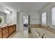 Relaxing bathroom with a double sink vanity and soaking tub providing a spa-like experience at 4495 Hedgewood Dr, Cumming, GA 30041