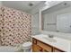 Bathroom featuring a toilet, floral shower curtain, and vanity sink at 4495 Hedgewood Dr, Cumming, GA 30041