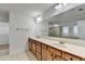 Bright bathroom featuring a double vanity with white countertops and tile flooring at 4495 Hedgewood Dr, Cumming, GA 30041