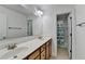 Bathroom featuring a double vanity with white countertops and a door to the toilet and shower area at 4495 Hedgewood Dr, Cumming, GA 30041