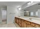 Bathroom with double sink vanity, large mirror, and tile flooring, along with a view of the shower and closet at 4495 Hedgewood Dr, Cumming, GA 30041