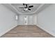 Bedroom showcasing trey ceiling, wood-look floors, and ensuite access at 4495 Hedgewood Dr, Cumming, GA 30041