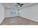 Spacious bedroom with tray ceiling, recessed lights, and wood-look floors at 4495 Hedgewood Dr, Cumming, GA 30041