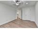 Bedroom with hardwood floors, white walls, and white doors. A view of the stairway is seen in the hallway at 4495 Hedgewood Dr, Cumming, GA 30041